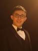 A person in a suit and bow tieAI-generated content may be incorrect.